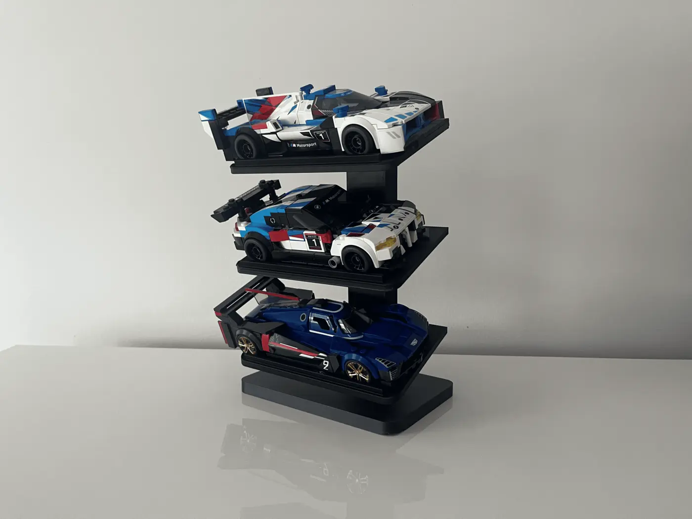 Axis three-tier display bringing a collection of race car builds together